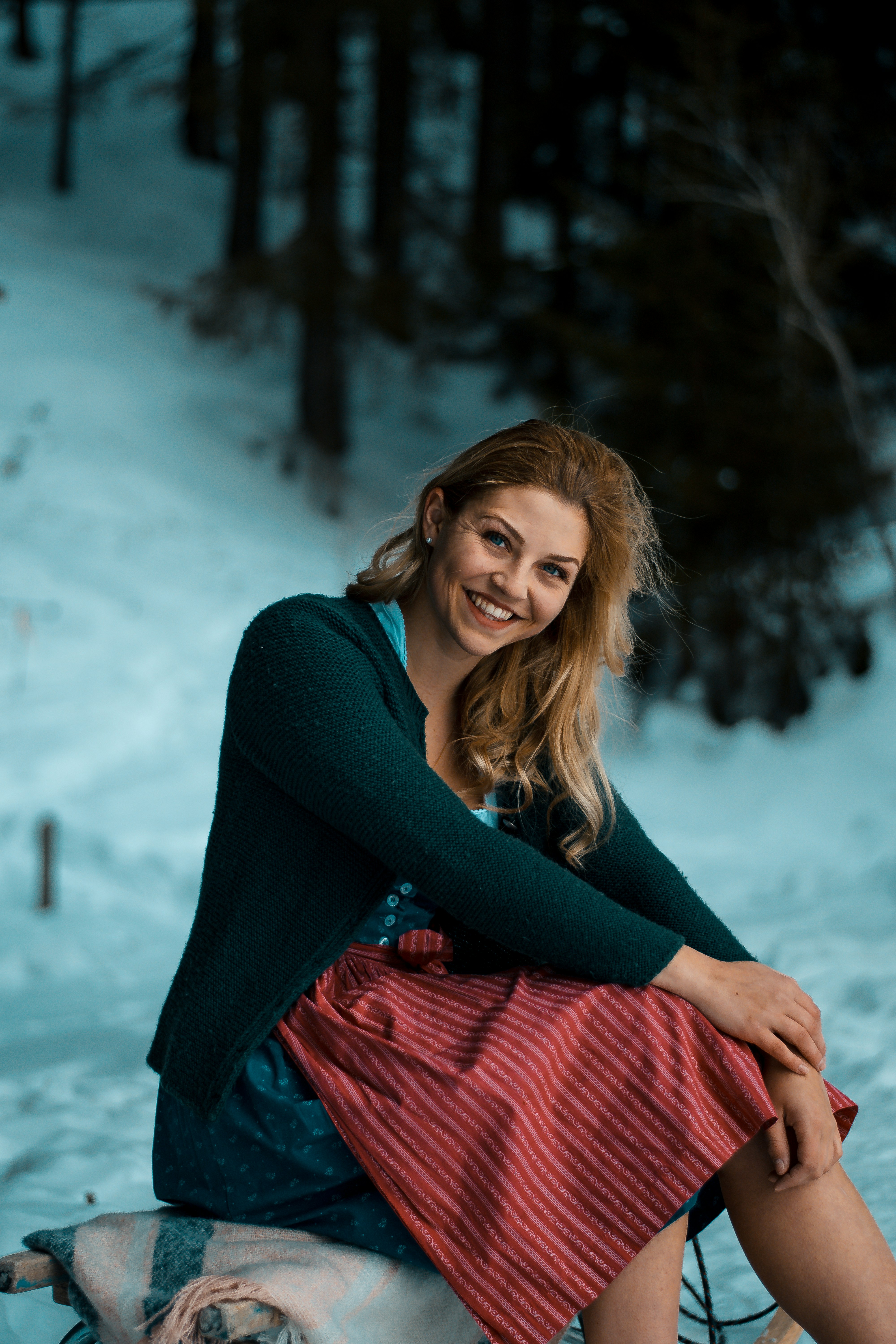 woman in black sweater and red and white plaid scarf